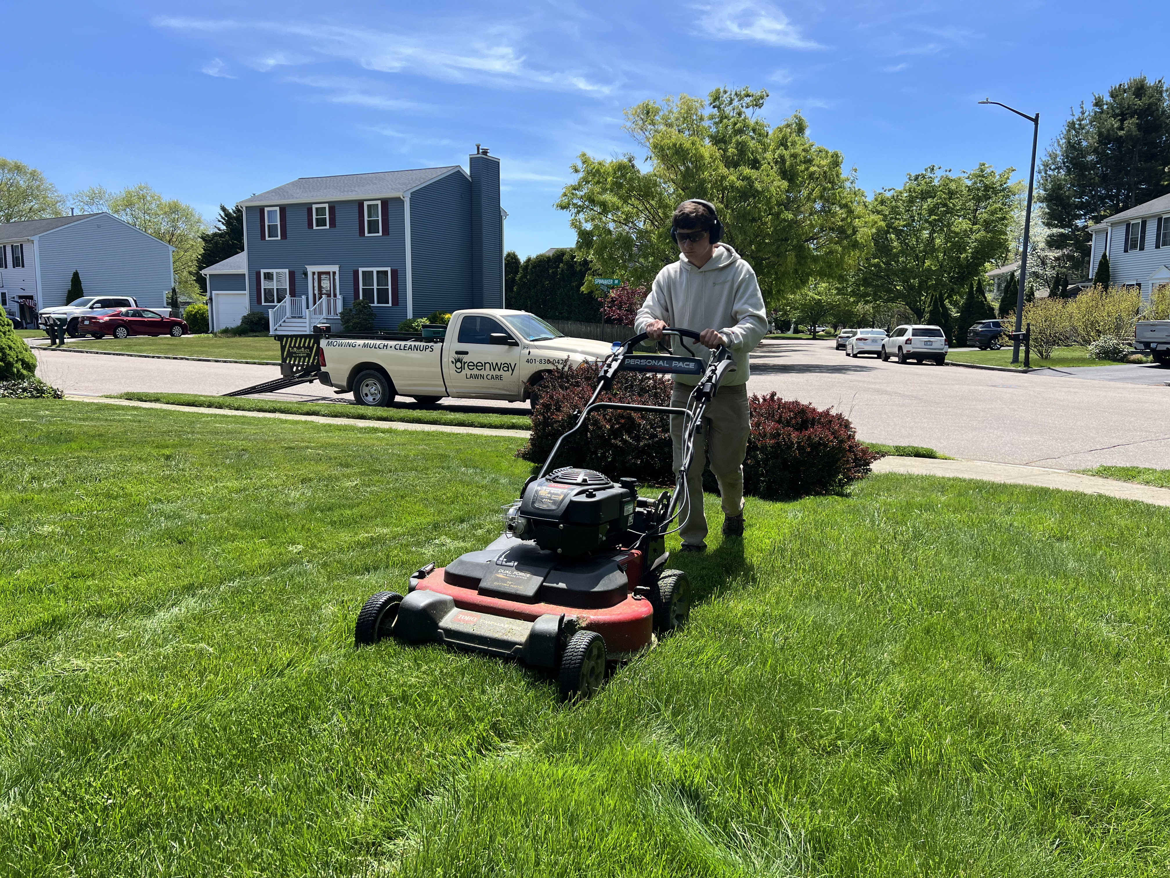 Greenway crew member mowing a lawn in the East Bay