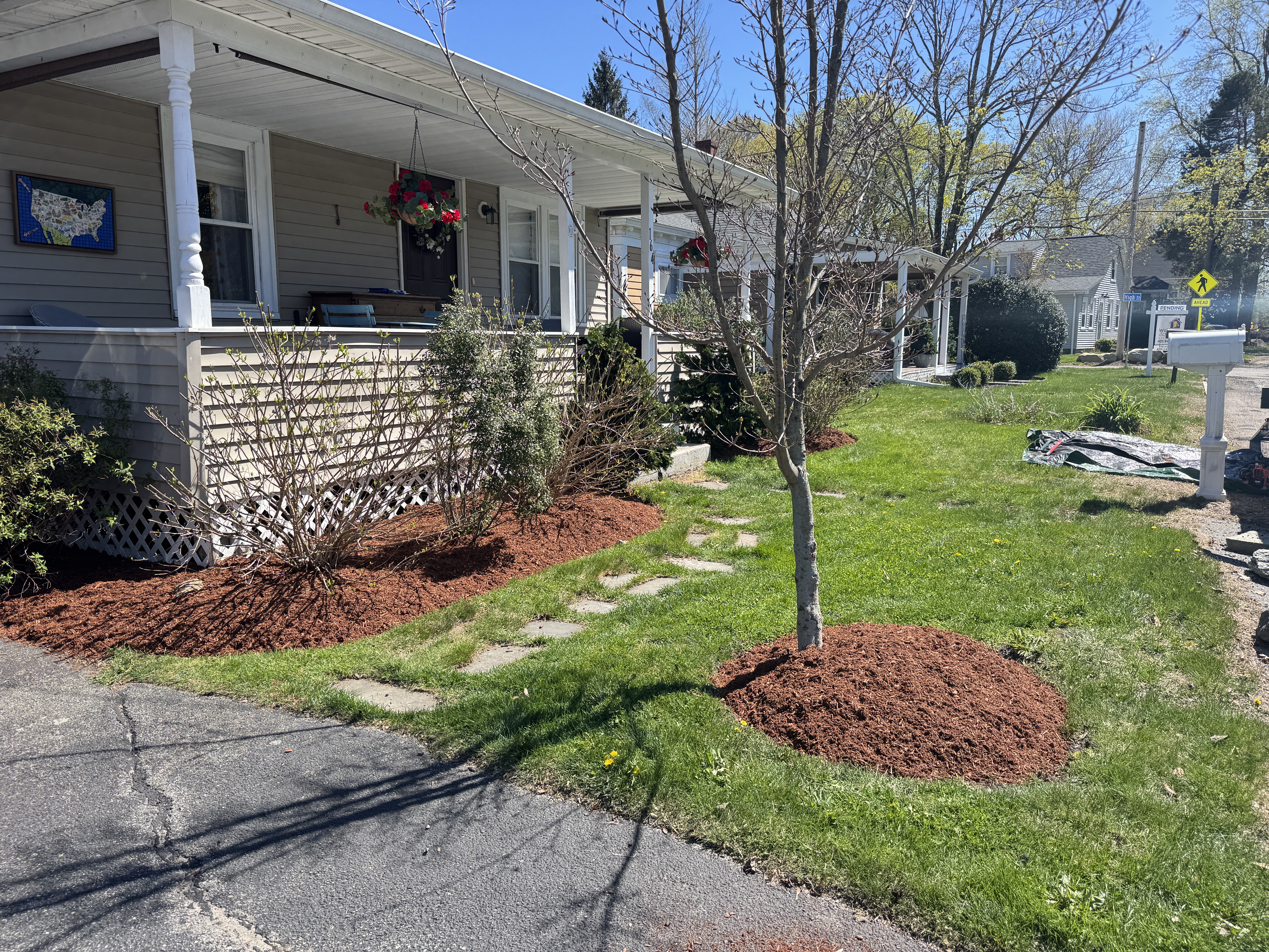 Red cedar mulch bed along a picket fence