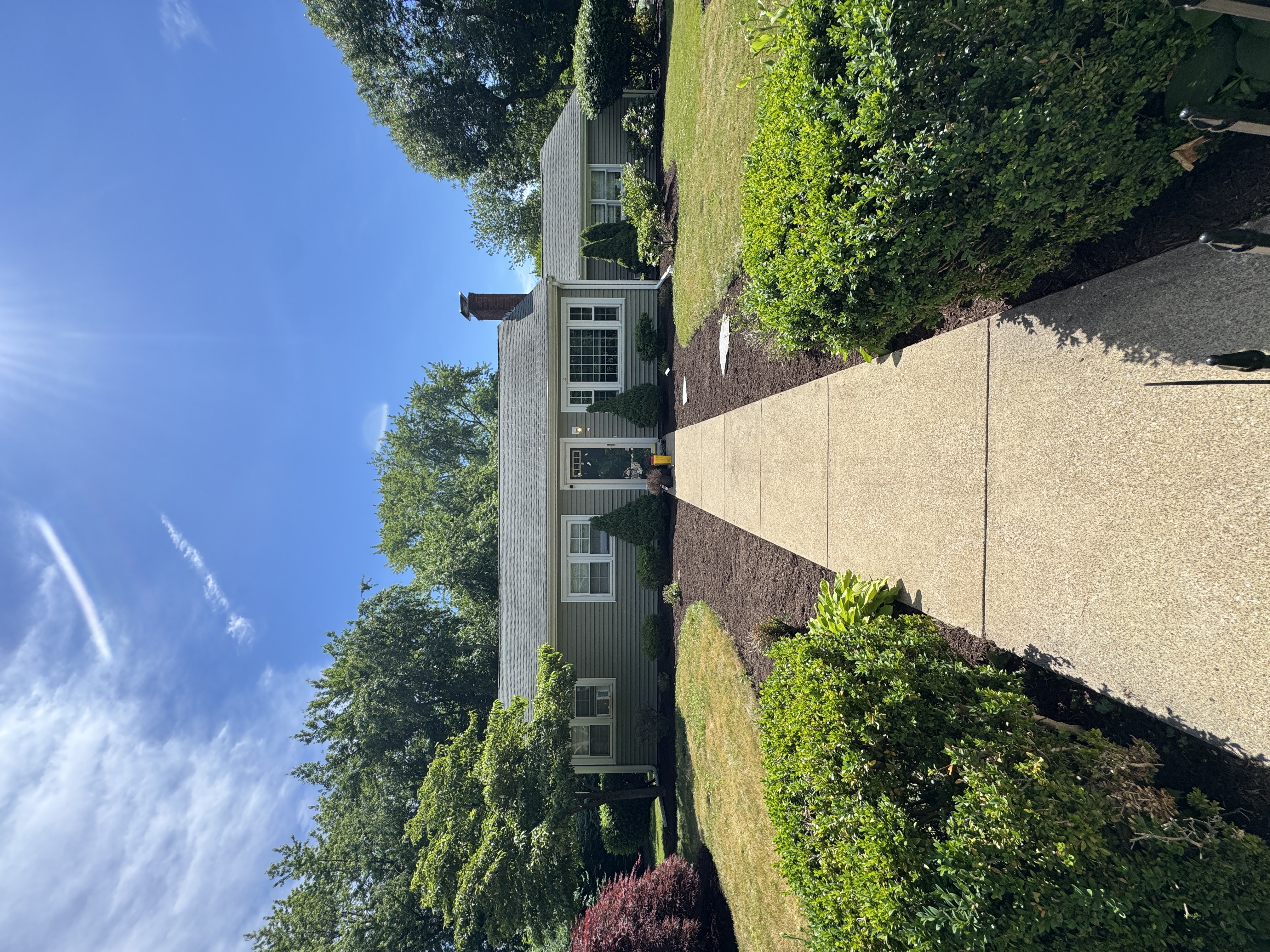 Freshly mowed lawn and edged walkway with tidy mulch beds